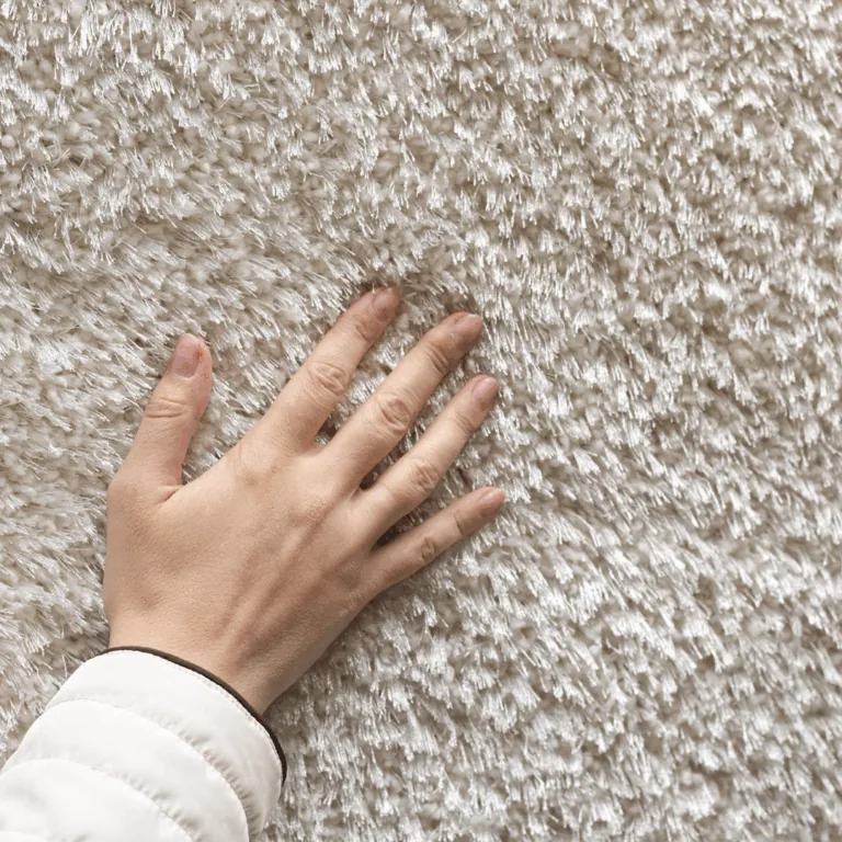 Hand touching soft carpet texture