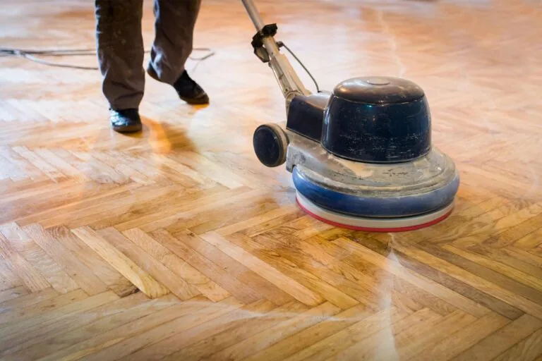 Wood floor sanding equipment refinishing original hardwood in an older home